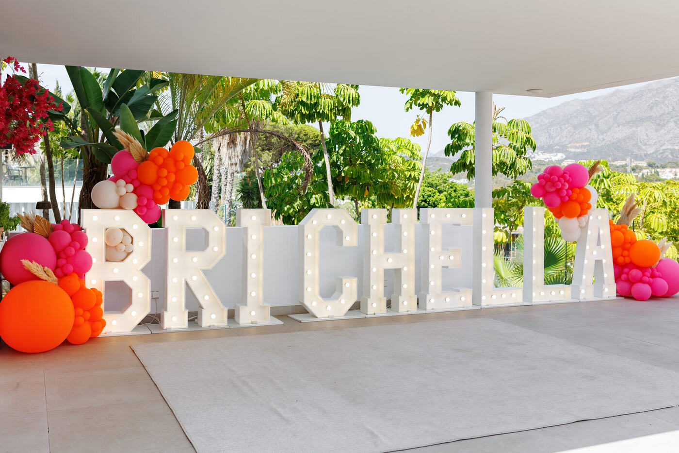 BRICHELLA marquee letters with pink and orange balloon clusters and pampas grass, Marbella villa