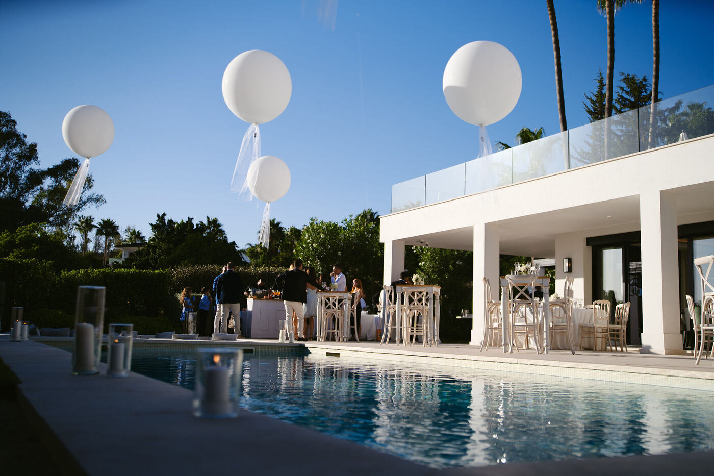 Guests on a villa terrace with jumbo round balloons, Marbella