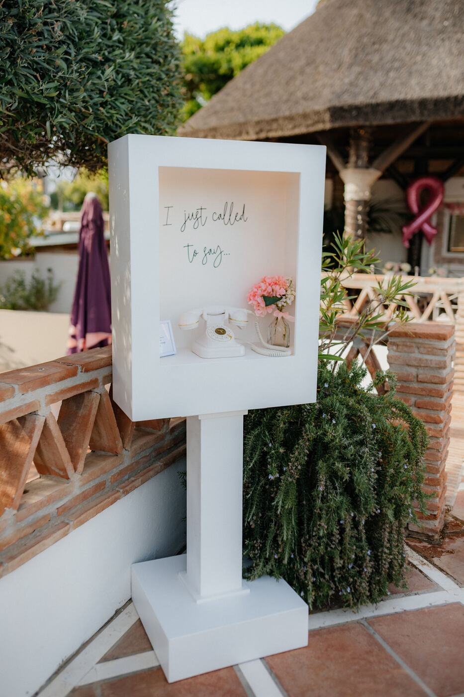 Retro telephone audio guest book with fresh flowers at a Marbella wedding